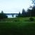 Brooklin area lakeside landscape in Acadia National Park with green field and lake in the distance.