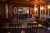 Inn dining room with dark wood paneling and warm lighting in Acadia National Park