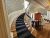 Historic interior with a grand curved staircase inside a Bar Harbor-area building in Acadia National Park.