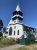 Northeast Harbor Church in Acadia National Park, a white wooden church with green trim and a tall steeple.