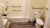 Bathroom with white tub and shower curtain, grab bars, toilet, towels and shelving in a lodge room at Acadia National Park