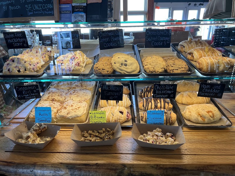 Bakery display in a Yellowstone National Park cafe showing trays of cookies, scones, cinnamon rolls, and brownies.