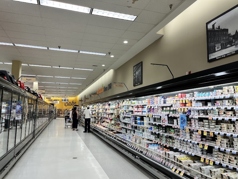 Gift Shop interior at Acadia National Park, shoppers browse a long refrigerated display of dairy and snacks.