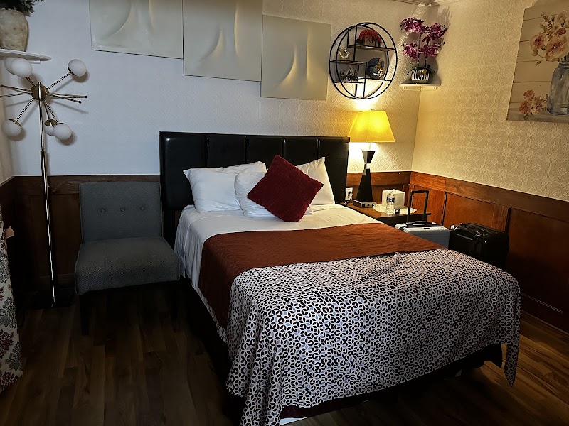 Cozy guest room at Atlantic Coast Inn in Acadia National Park, with a plush bed and warm lighting.
