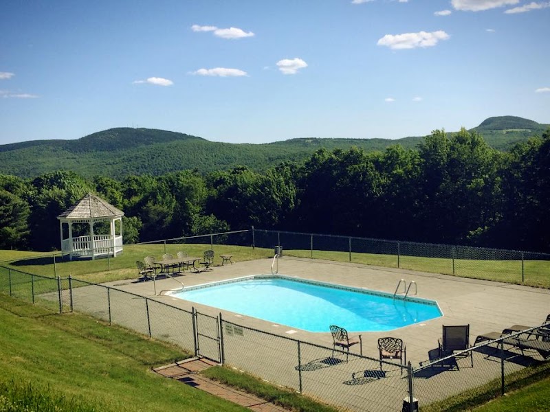 Lucerne Inn pool area with gazebo and forested mountains in Acadia National Park