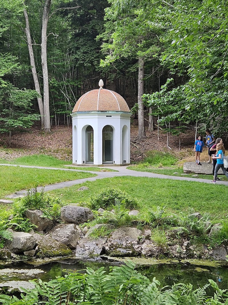 White domed gazebo at the Wild Gardens of Acadia, a tranquil floral display within Acadia National Park.
