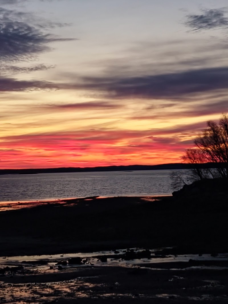 Sunset over the rocky shoreline along Acadia National Park’s coast at dusk.