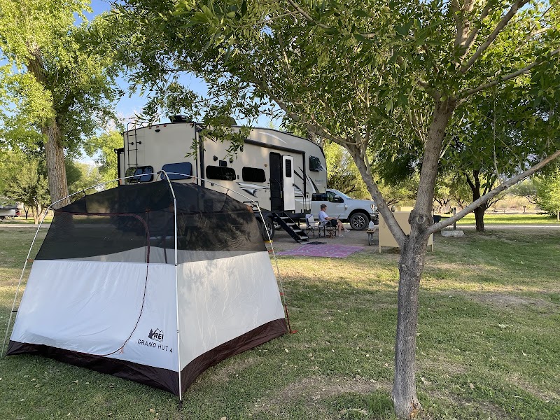 Cottonwood Campground, Big Bend National Park, shows a large RV beside a two-tone tent under shady cottonwood trees.