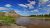 The Little Missouri River bends past eroded chalk cliffs in Theodore Roosevelt National Park under a vivid blue sky.