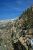 Rocky, snow-dusted ridge with tall pines along a jagged canyon slope in Sequoia & Kings Canyon National Parks.