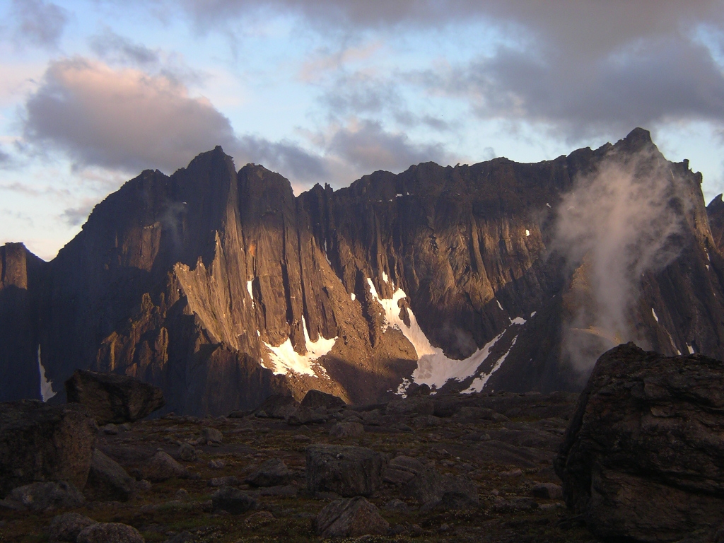 Gates of the Arctic National Park & Preserve rugged alpine peaks rise above a rocky foreground at sunset.