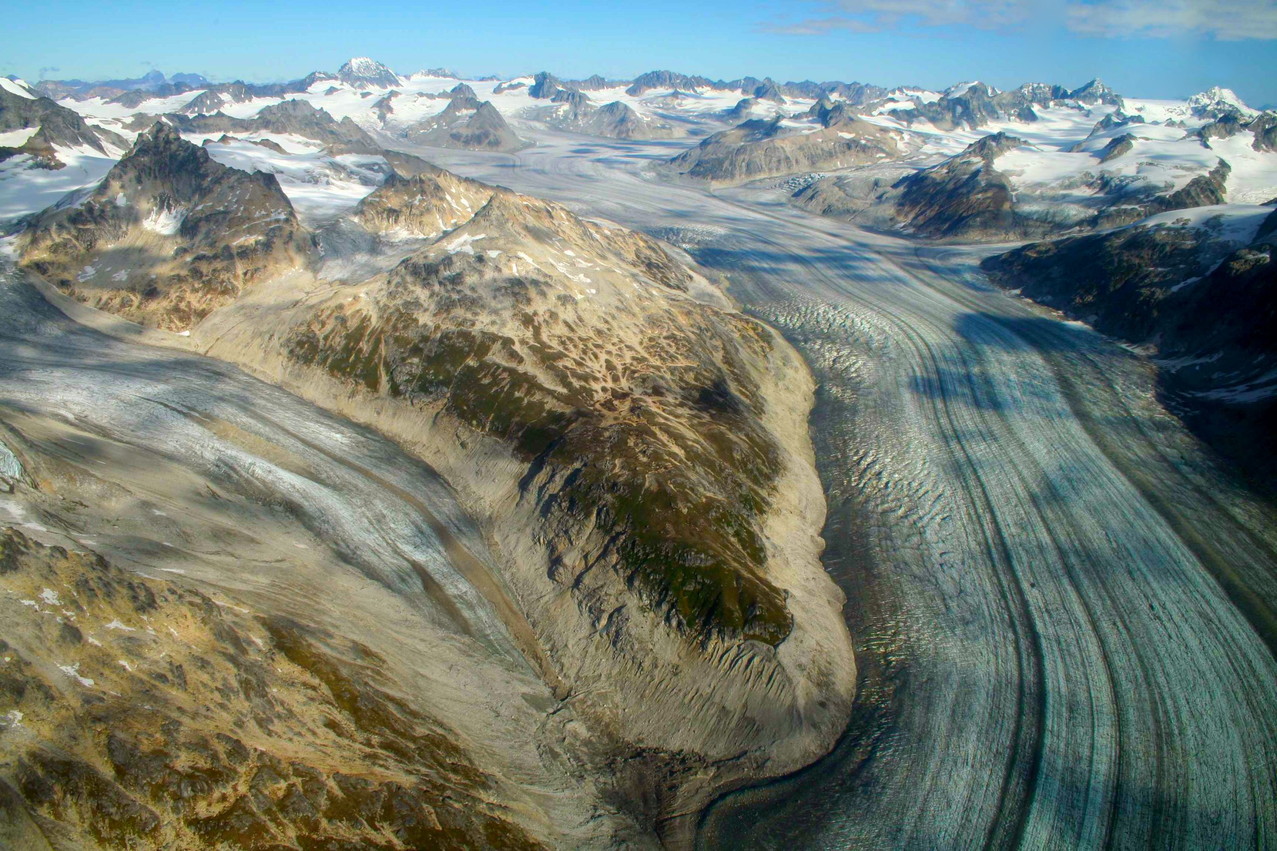 Glacier-filled valley and rugged peaks in Lake Clark National Park & Preserve, Alaska, as a wide glacier snakes through the mountains.