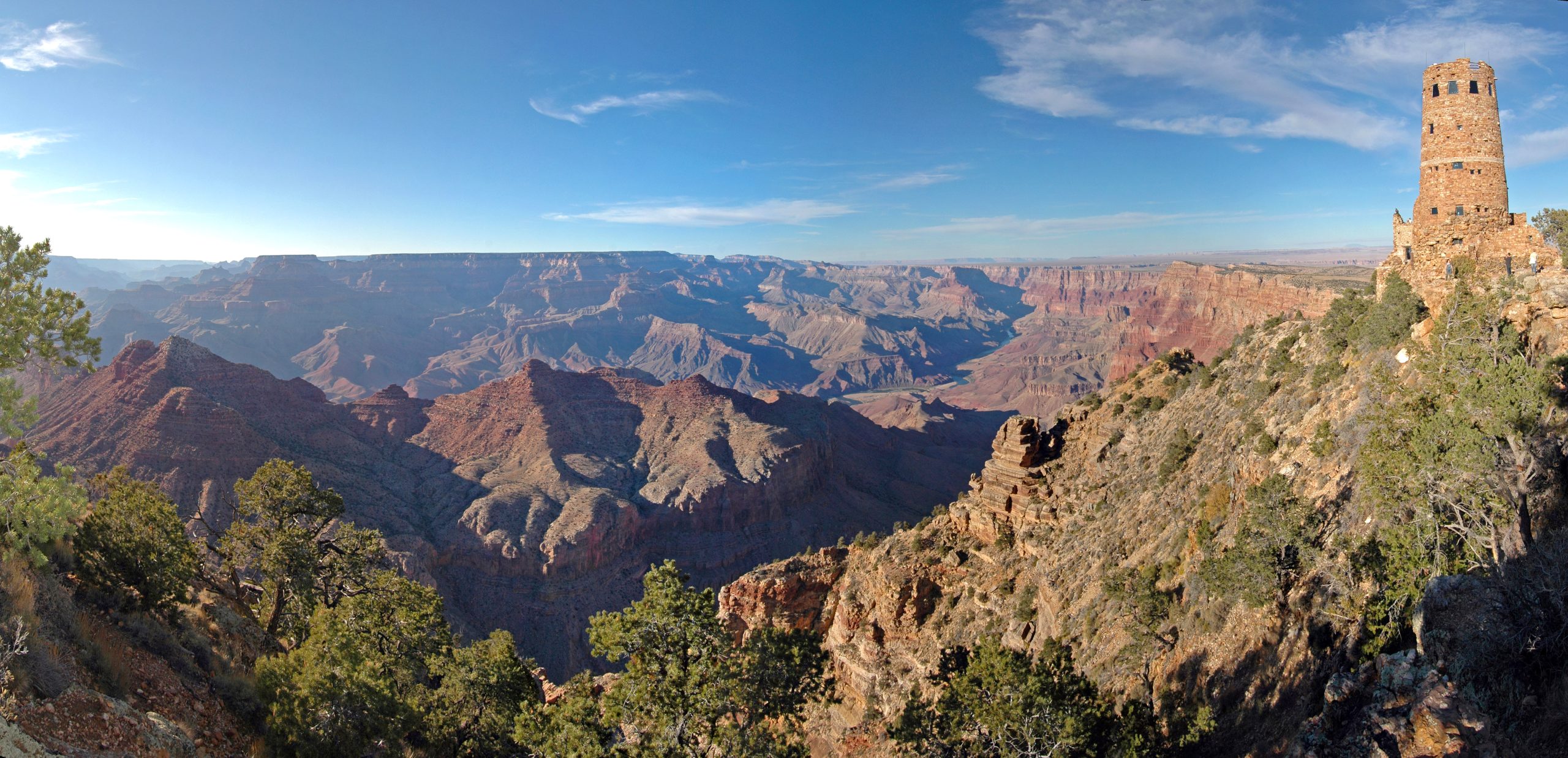 Desert View Watchtower atop the Grand Canyon's rim, overlooking layered red rock formations.