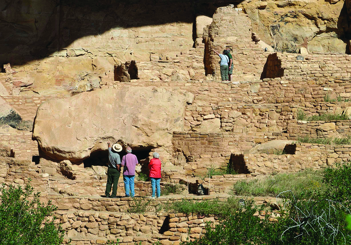 Visitors explore the Cliff Palace cliff dwellings in Mesa Verde National Park, Colorado.
