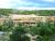 Cliff Palace cliff dwellings at Mesa Verde National Park nestled in a sandstone alcove amid pinyon and juniper trees.