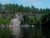 Rocky shoreline along Rainy Lake with layered granite cliffs and pine trees at Voyageurs National Park.