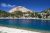 Manzanita Lake at Lassen Volcanic National Park with Lassen Peak towering above a forested shore.