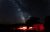 Night sky over Wheeler Peak Lodge at Great Basin National Park, with a red-lit lodge exterior along a winding road.