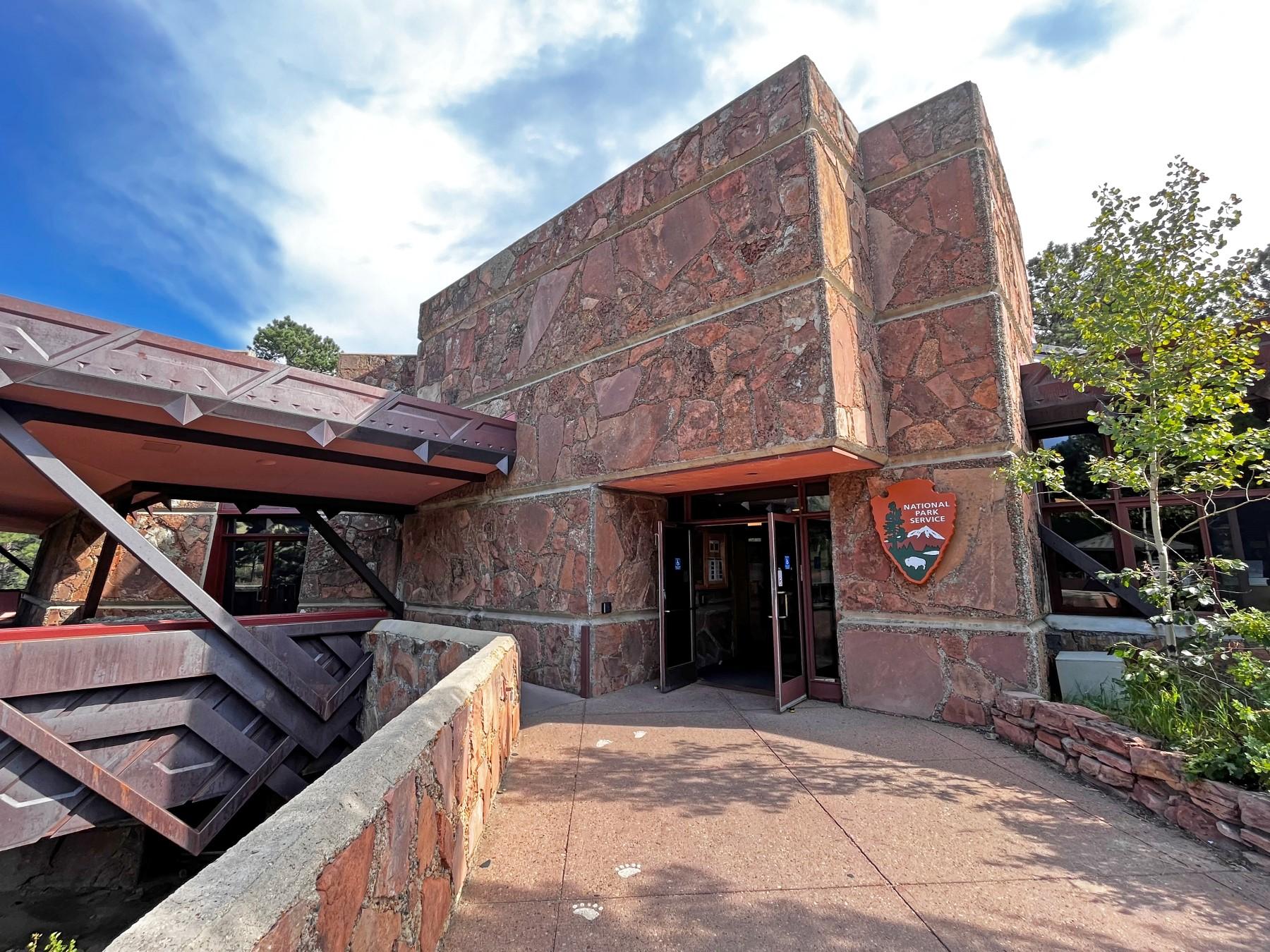 Alpine Visitor Center at Rocky Mountain National Park with red stone walls and distinctive angular metal detailing.