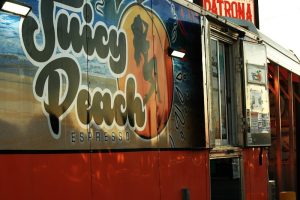 Espresso cart at Carlsbad Caverns National Park near the visitor entrance, with a colorful Juicy Peach Espresso design on the side.