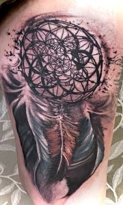 Geometric mandala circle tattoo with feather motifs on upper arm, inspired by Congaree National Park.