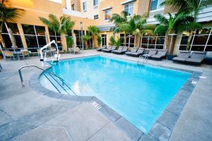 Goleta hotel pool courtyard near Channel Islands National Park, surrounded by palm trees.