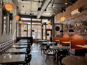 Interior dining area inside Congaree National Park area, featuring brick walls, leather seating, and warm pendant lighting.