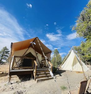 Under Canvas Bryce Canyon glamping tents set up near Bryce Canyon National Park under a clear blue sky.