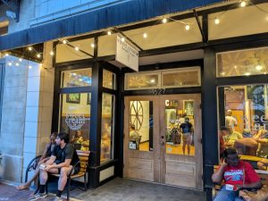 Sweet Cream Co storefront along park entrance in Congaree National Park, warmly lit with string lights.