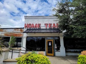 Restaurant storefront with neon sign and glass doors in Congaree National Park area.