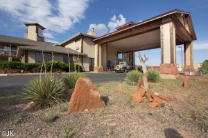 Noor Hotel entrance at Capitol Reef National Park, a motel-style lodging along the park road with desert landscaping and red rock accents.