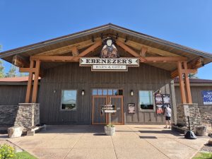 Rustic barn-style restaurant entrance at Bryce Canyon National Park, with wooden beams and a peaked roof.