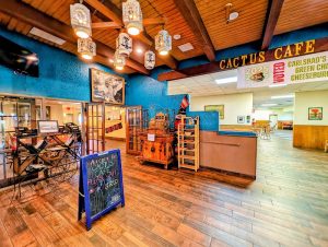 Cafe interior in Carlsbad Caverns National Park, featuring teal walls, wooden beams, and rustic decor near the park's visitor area.