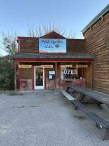 Rustic cafe building at Capitol Reef National Park with a wooden facade and outdoor seating area in front.