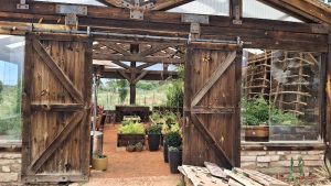 Wooden barn doors open into the Wright Family Ranch campground building at Zion National Park.