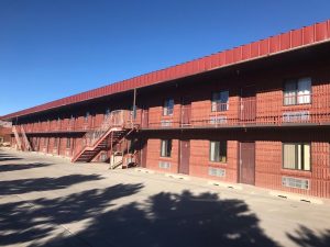 Lodging complex exterior at Capitol Reef National Park, a red brick two-story building with outer stairways.