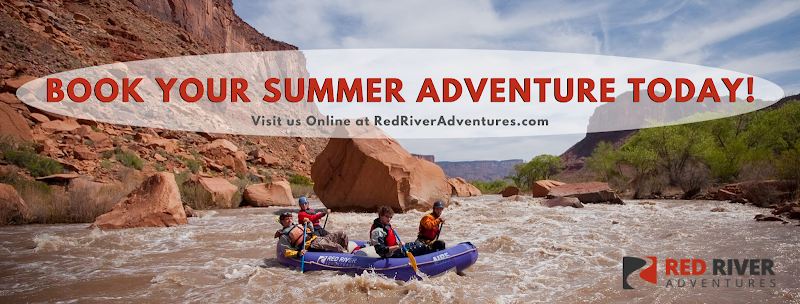 Rafting the Colorado River beneath red canyon walls near Canyonlands National Park as a guided group navigates whitewater.