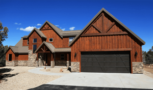 Rustic lodge-style residence with timber exterior and stone accents, fronting a wide driveway in Zion National Park.