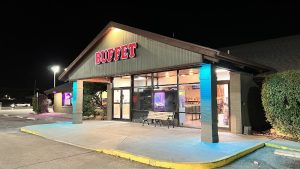Chinese buffet restaurant exterior near Carlsbad Caverns National Park at night, neon lighting and parking lot.