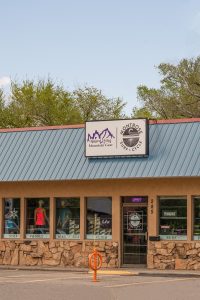 Gift shop storefront in Black Canyon of the Gunnison National Park, with apparel and gear in display windows.
