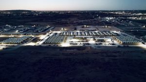 Lodging complex at Carlsbad Caverns National Park, rows of illuminated buildings stretch across the desert nightscape near the cavern area.