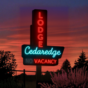 Lodging neon sign glows at dusk beside desert flora in Black Canyon of the Gunnison National Park.
