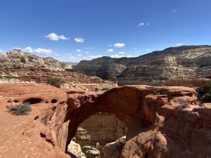 Cassidy Arch trail winds along red sandstone cliffs in Capitol Reef National Park.