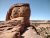 Delicate Arch rises beside a clear blue sky at Arches National Park, a famed sandstone formation.