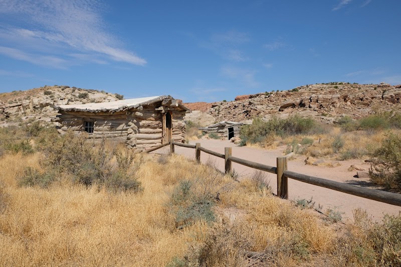 Delicate Arch viewing area near a rustic log cabin in Arches National Park