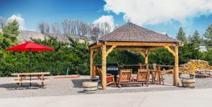 Wooden gazebo with a grilling area and seating at Black Canyon Of The Gunnison National Park lodge.