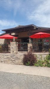 Cafe patio with red umbrellas and stone railing at Black Canyon Of The Gunnison National Park.