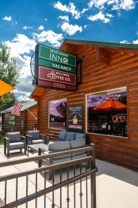 Rustic log building houses a cafe with outdoor seating in Bryce Canyon National Park, Utah.