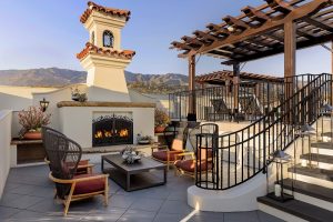 Hotel rooftop terrace with a lit fireplace and lounge seating at Channel Islands National Park.