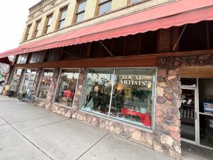 Main Street gift shop storefront with red awning and stone facade in Black Canyon of the Gunnison National Park.